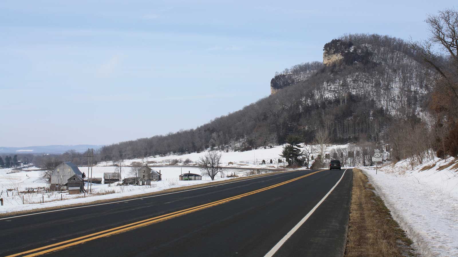 Winter Drive on the Great River Road with scenic bluff in the distance